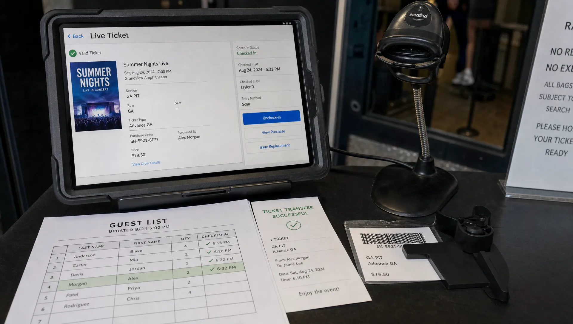 Landscape close-up inside an event check-in station, focused on a live ticket record screen facing the camera beside a paper guest list with updated names, a transfer confirmation slip, and a partially covered barcode card kept out of use. The surrounding desk, scanner cradle and door-team tools place the details in their real operational context.
