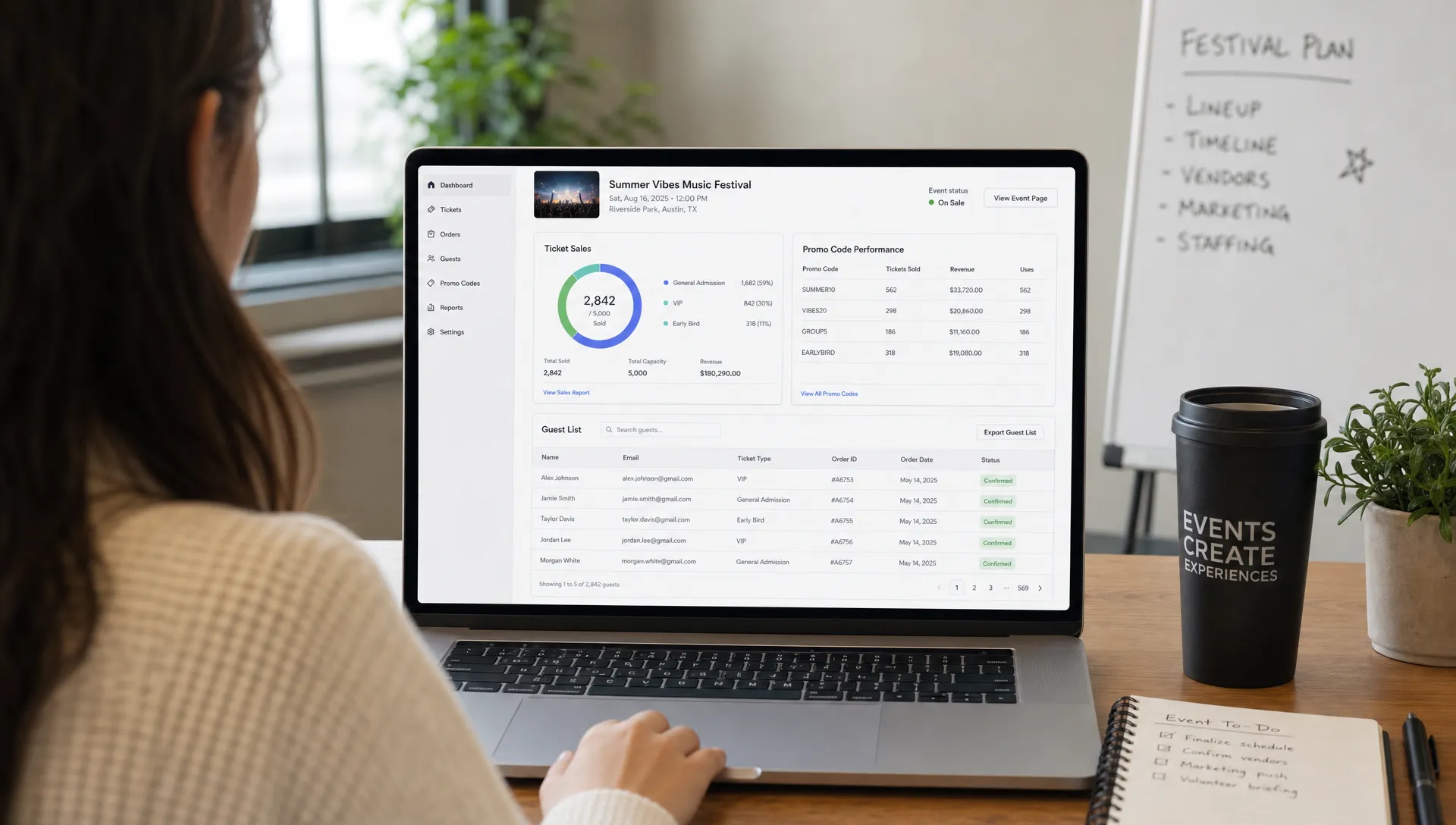 An event organizer reviews a laptop open toward them with the screen visible from the front, showing a simple ticket sales dashboard with ticket tiers, promo code performance, and a digital guest list for an upcoming live event.