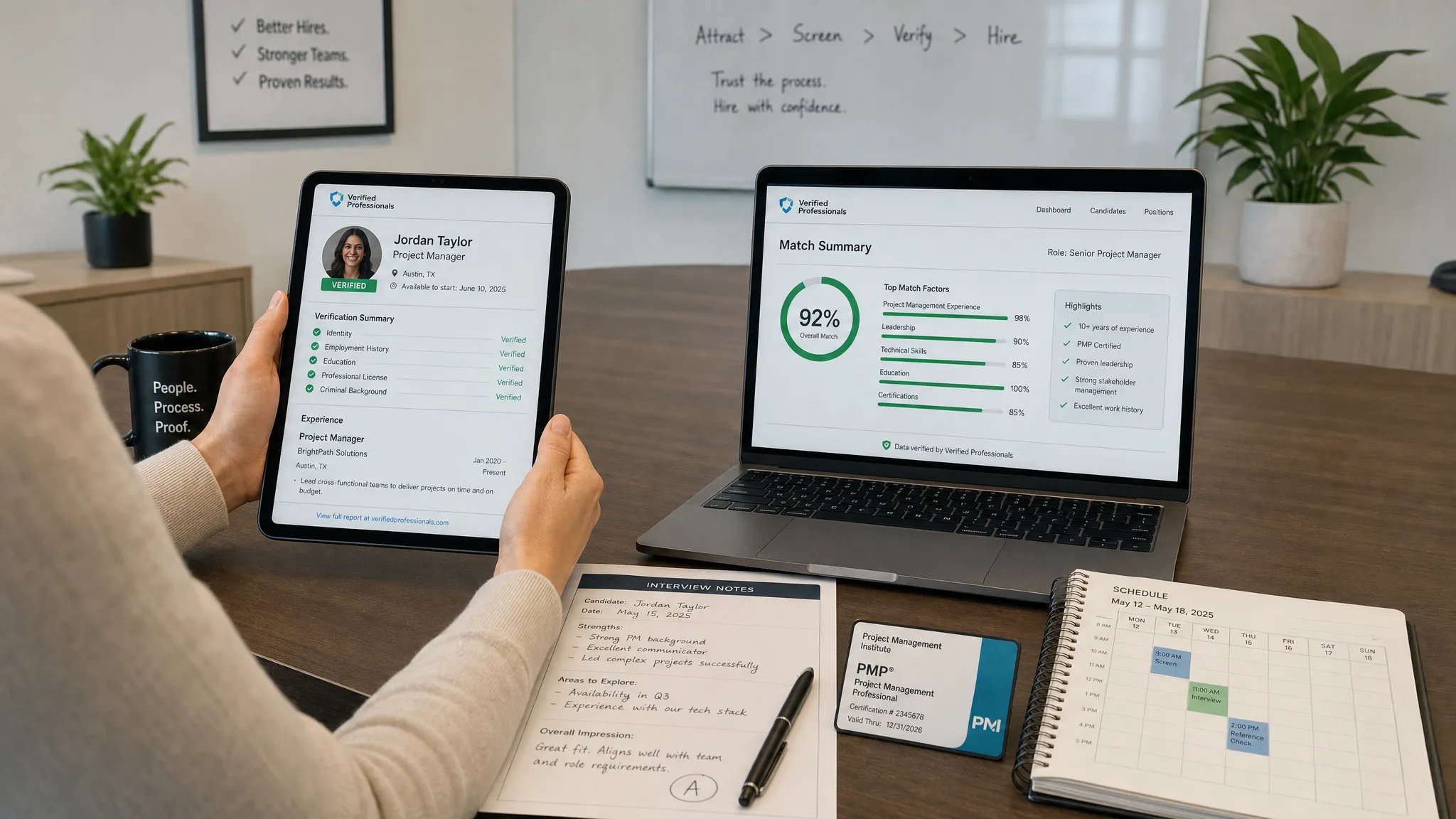 Wide indoor scene in a modern strategy room showing a clear chain of trust in hiring: a recruiter seated at a table reviews a verified candidate profile on a tablet facing the camera, while a laptop beside it shows a clean matching summary facing the camera, and printed interview notes, a credential card, and a scheduling calendar are arranged around them. The composition should feel organized and evidence-focused, with no other people visible.
