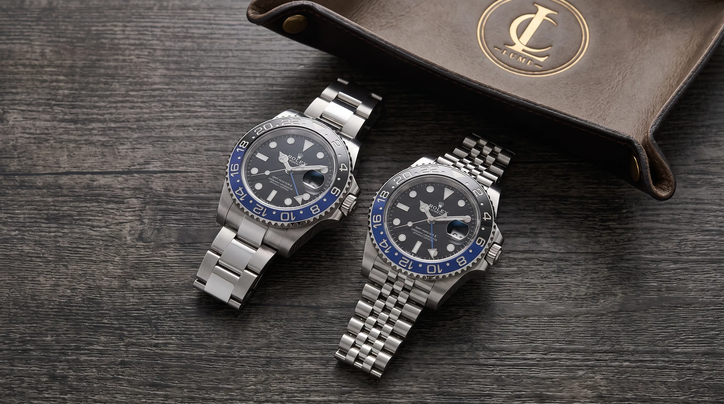 Two GMT-Master II BLNR watches are shown side by side, one on Oyster and one on Jubilee, with the black-and-blue bezels and bracelet fit visible.