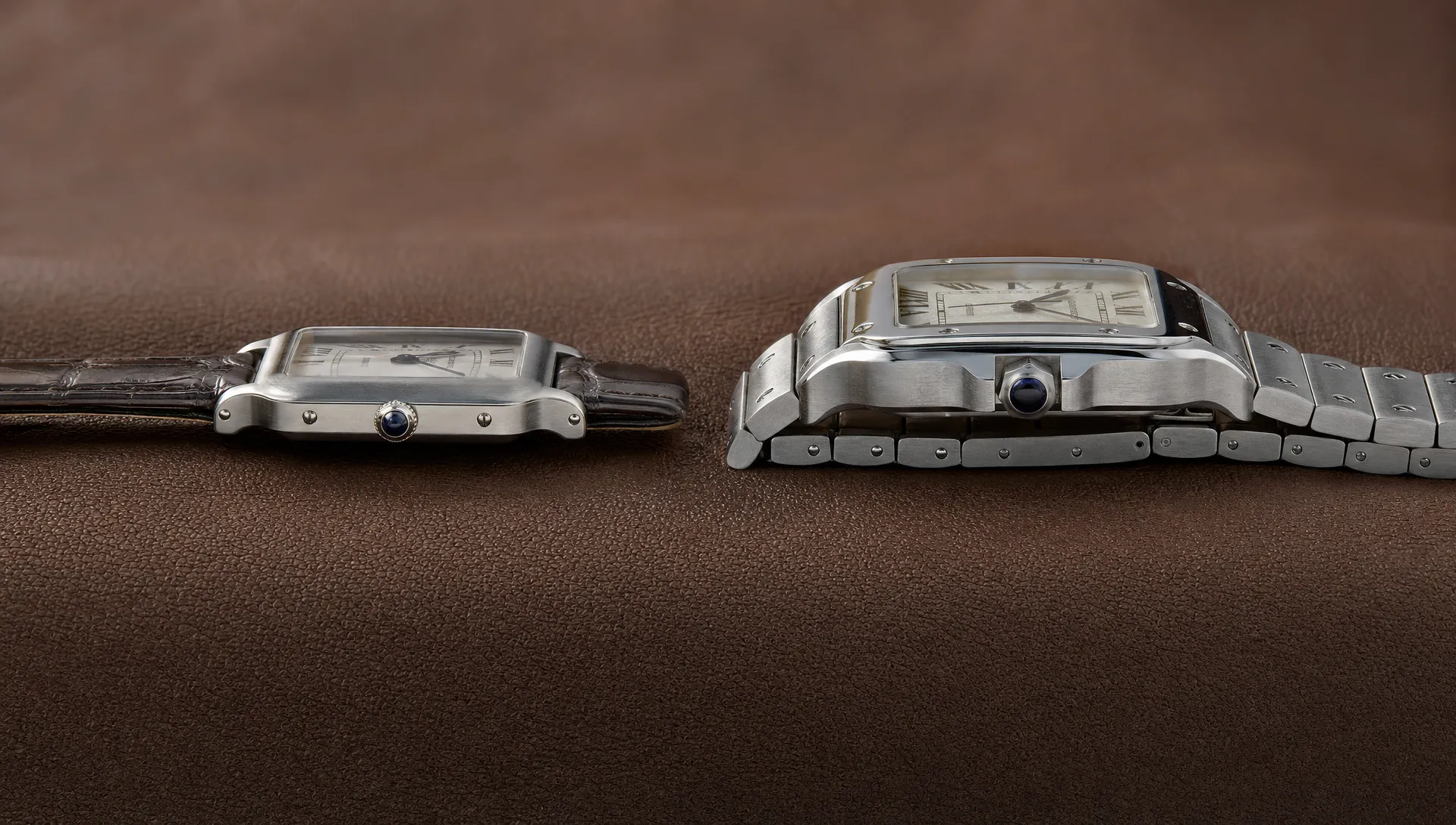 A Santos-Dumont on leather beside a medium Santos de Cartier on bracelet shows their different profiles.