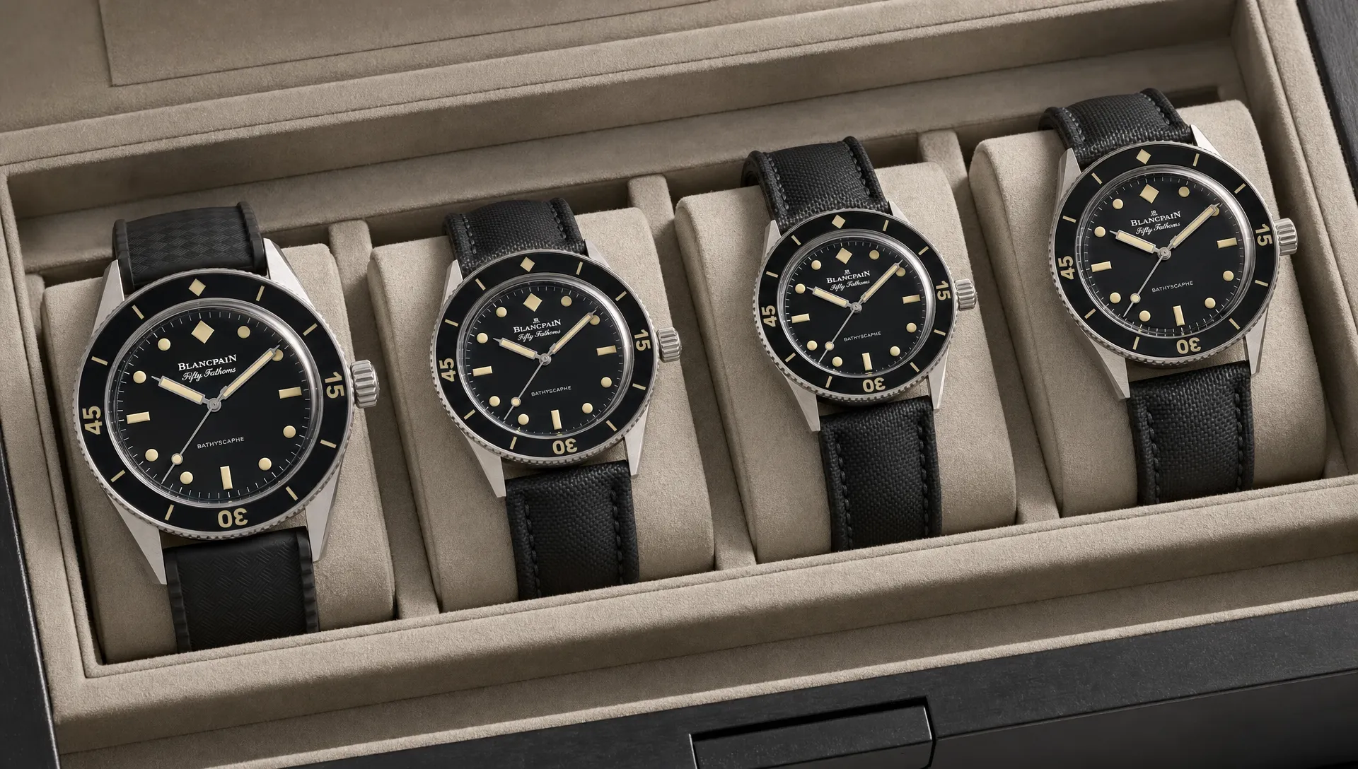 A group of Blancpain-inspired luxury dive watches arranged on a neutral watch tray, showing different case sizes, rotating bezels, black dials, vintage-style markers and rubber or sailcloth straps.