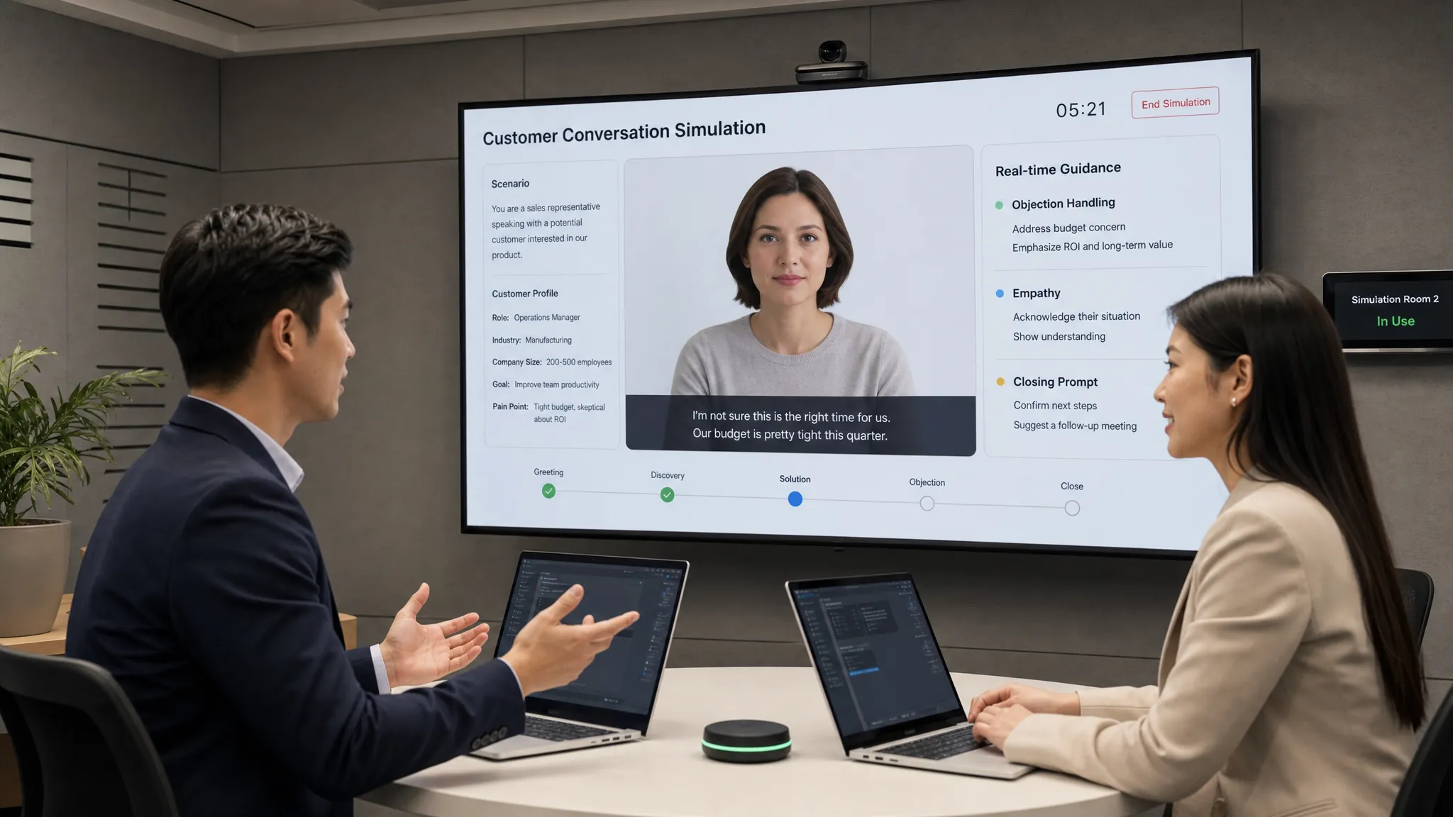A sales rep and a service agent practicing customer conversations in a simulation room, with one speaking while the other listens and responds to objections, empathy, and closing prompts around them.