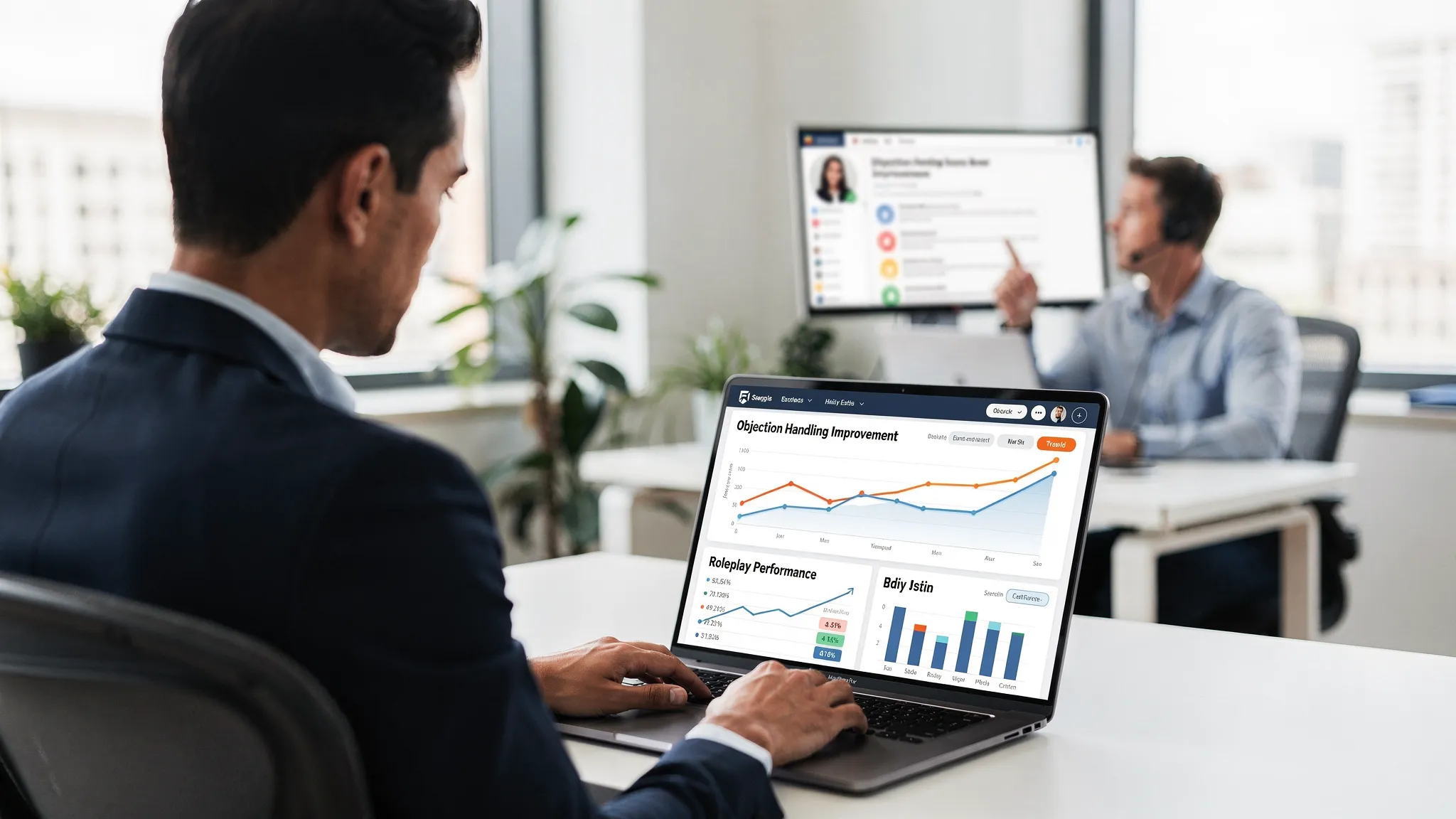 A sales enablement manager reviewing roleplay performance analytics on a laptop screen facing the viewer, with charts showing improvement in objection handling and a rep practicing a simulated call in the background.