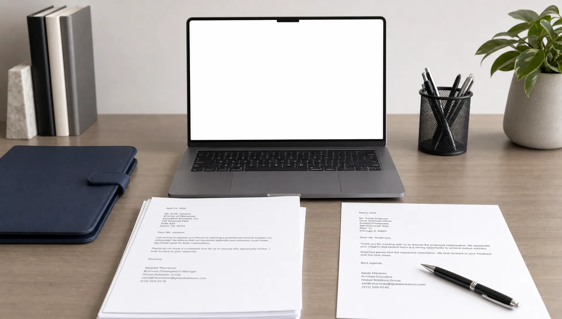 A clean office desk with printed professional letters, a pen, a folder, and a laptop screen facing the viewer with nothing displayed behind it, suggesting organized PDF letter preparation.