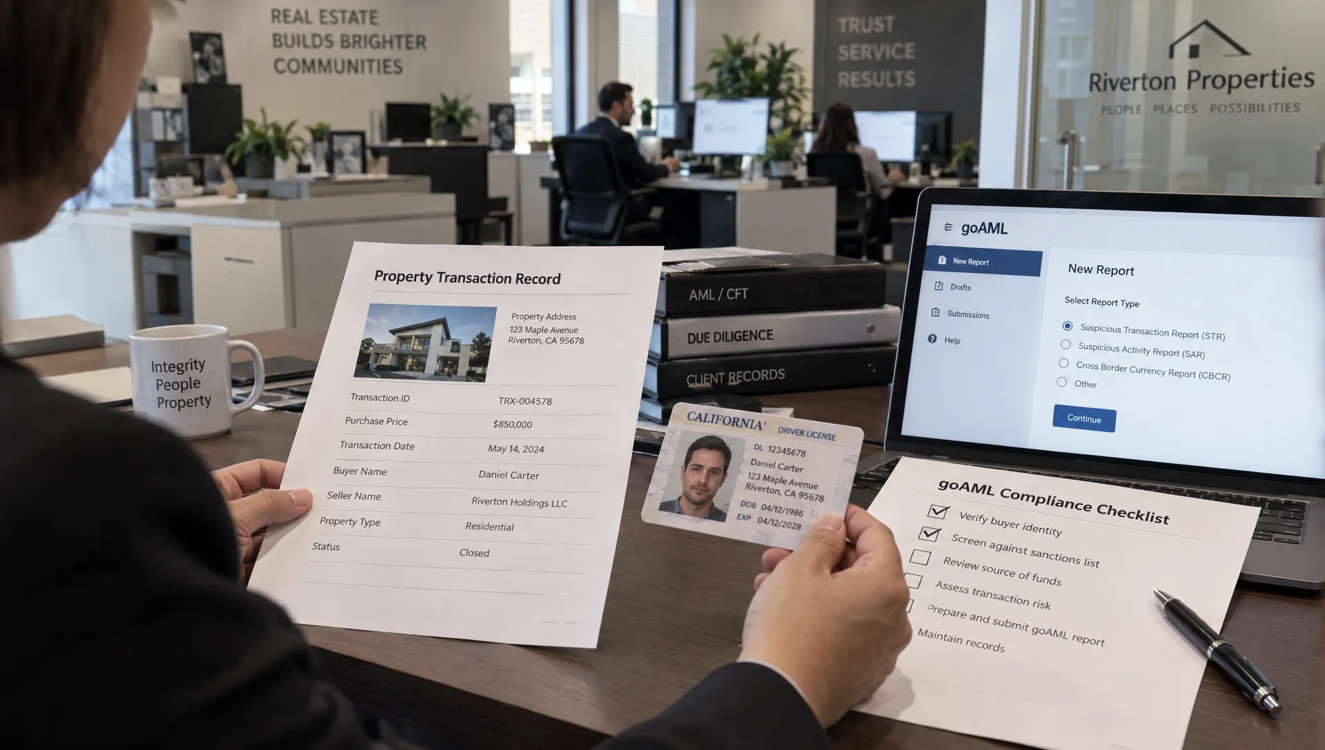 A compliance officer's hands compare a property transaction record with buyer identification and a goAML checklist at a brokerage worktable, with the active office visible beyond.