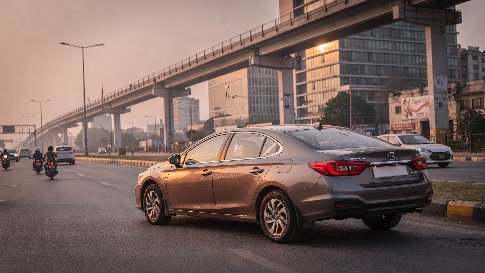 A clean used sedan parked on a wide Delhi-Gurugram urban road with metro pillars, office buildings and light evening traffic in the background.