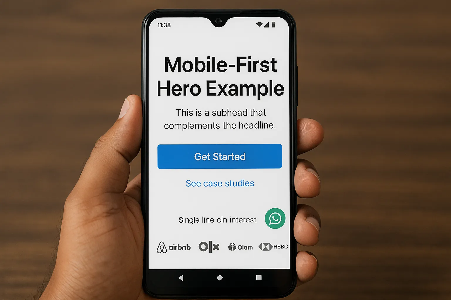 Mobile-first hero example viewed on a popular Android device in India: clear headline, concise subhead, high-contrast primary CTA button, secondary link to case studies, WhatsApp icon for quick questions, and a single line of client logos.