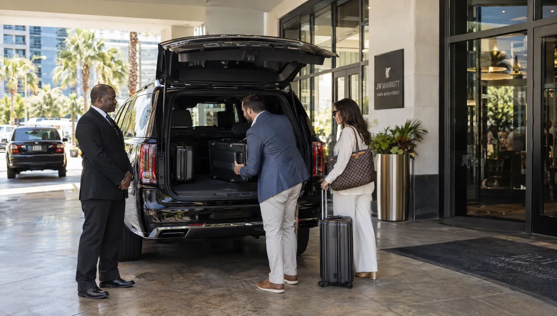 A chauffeur and travelers load suitcases into a luxury SUV for a scheduled limo service Tampa round trip.