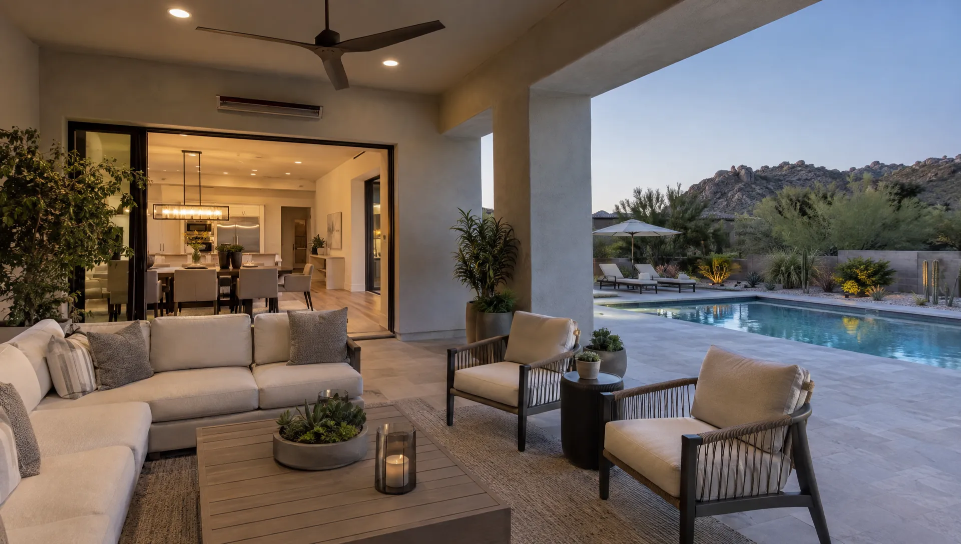 A shaded Scottsdale patio beside the pool provides an outdoor place to relax, with the home's dining area visible through open doors.