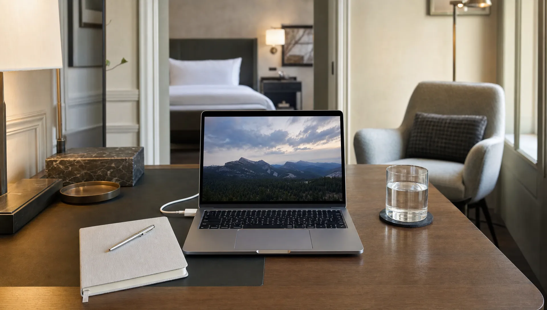 A laptop and notebook on a vacation rental desk show a practical setup for remote work during a longer stay.