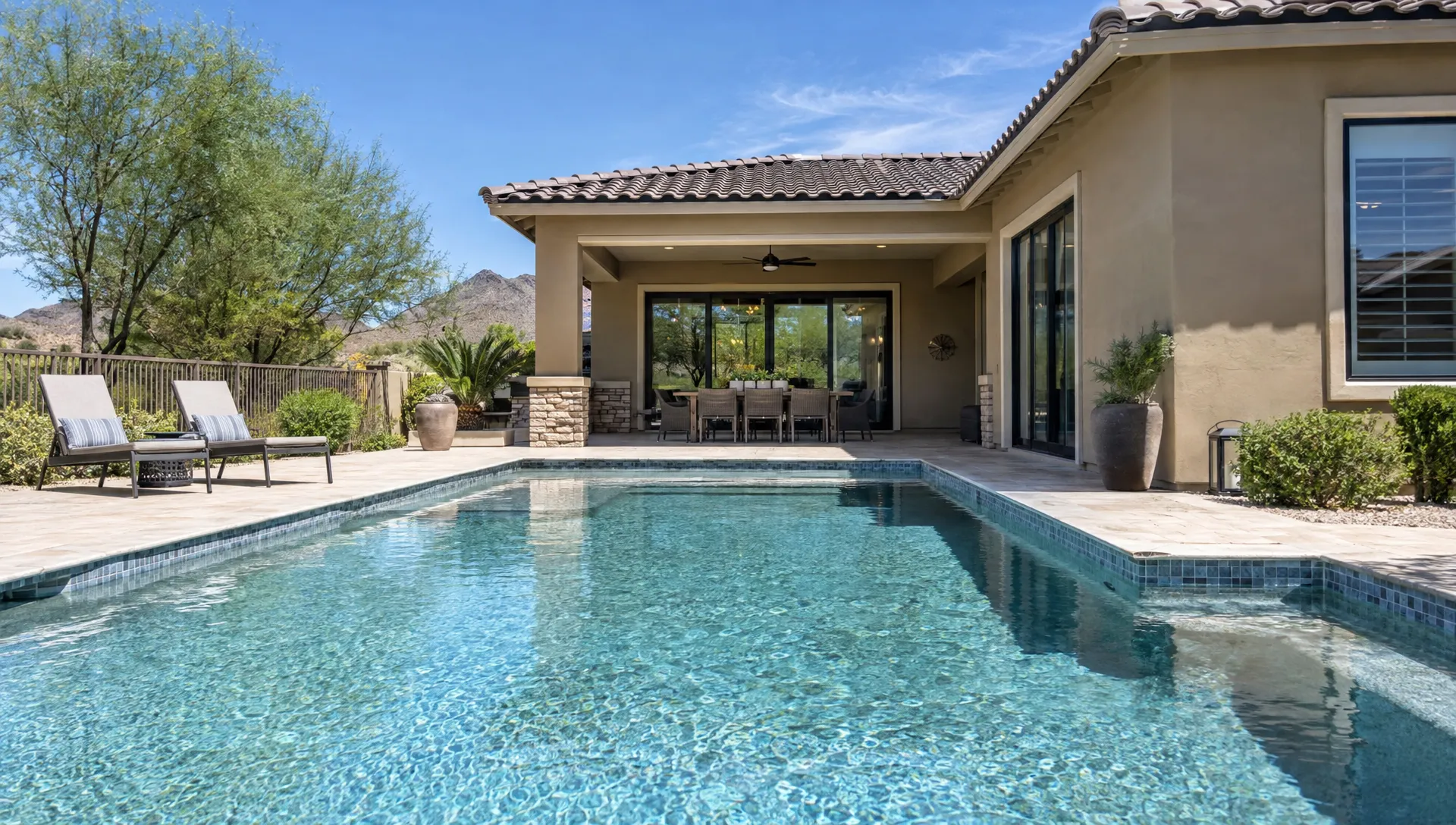A well-maintained Scottsdale vacation rental has a private pool, covered dining patio, and tidy desert landscaping.